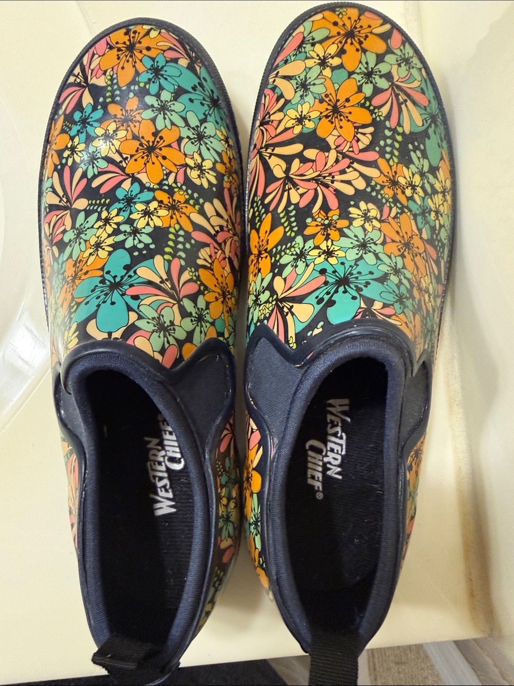 Western Chief Floral Slip-On Rain Shoes in Black, Orange, Teal & Pink